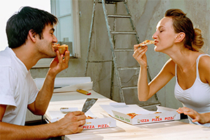 Man and woman eating pizza together