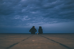 Man and woman sat outside talking.