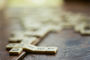 Scrabble board with the word "quiet" spelt.