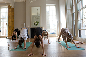 A group of women doing yoga.