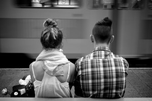 Woman and man sitting side-by-side in an airport.