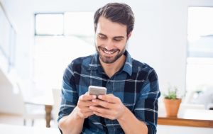 Man smiling at his phone