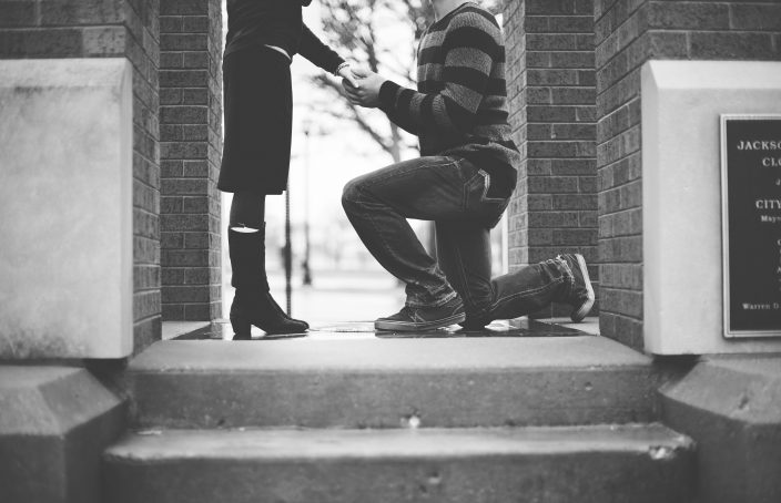 Man on one knee proposing to his girlfriend