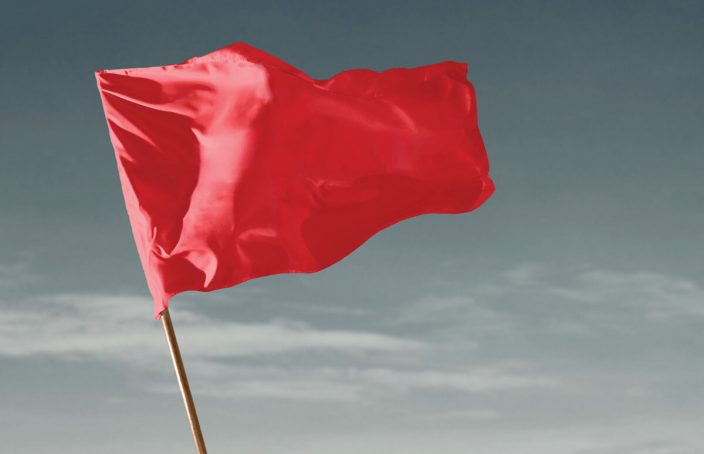 red flag blowing in the wind