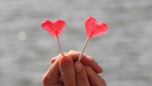 heart lollipops holding hands