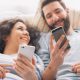 couple on phones in bed