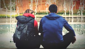 man and woman sitting together